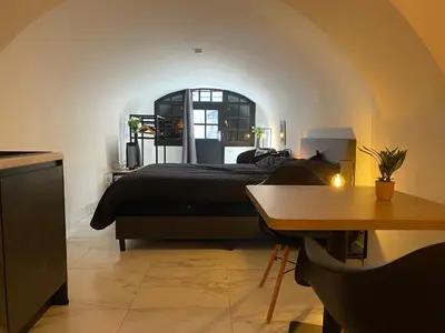 a bedroom with a bed and a table and a table sidx sidx sidx at Slapen onder de Dom in Utrecht