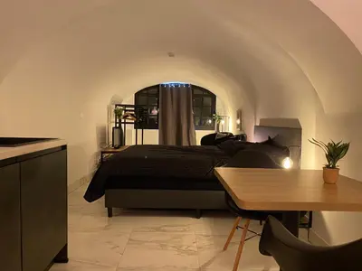 a bedroom with a bed and a table at Slapen onder de Dom in Utrecht