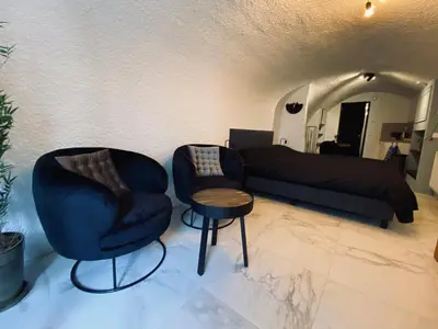 a living room with two chairs and a couch at Slapen onder de Dom in Utrecht