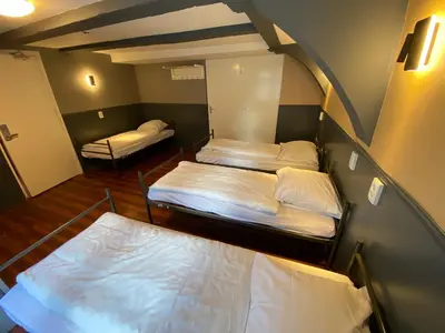a small room with two beds in it at Xplore Hostel Amsterdam in Amsterdam