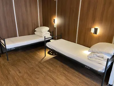 a room with two bunk beds in a ship at Xplore Hostel Amsterdam in Amsterdam