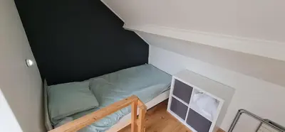 a small room with a bunk bed in a attic at Ferienhaus Abenteuer in Egmond aan Zee