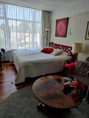 a bedroom with a bed and a coffee table at Cosy appartement Wassenaar in Wassenaar