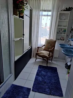 a bathroom with a chair and a sink at Cosy appartement Wassenaar in Wassenaar
