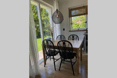 a dining room with a table and chairs at Have a nice stay! - Raaff-71 sfeervol huis direct bij bos, duin en strand in Noordwijk