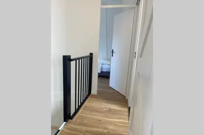 a hallway with a door leading to a bedroom at Have a nice stay! - Raaff-71 sfeervol huis direct bij bos, duin en strand in Noordwijk
