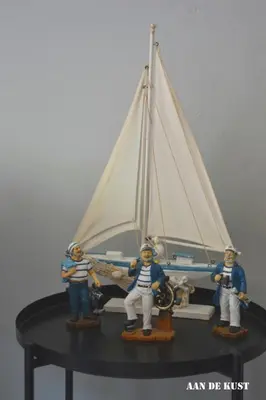 a toy boat with three figurines on a table at Zomerhuis 