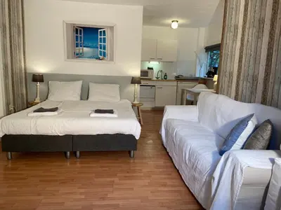 a living room with a bed and a couch at Gartenblick in Zandvoort