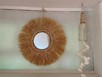 a mirror hanging on a wall with a vase at Gartenblick in Zandvoort
