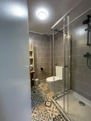 a bathroom with a glass shower and a toilet at Gartenblick in Zandvoort