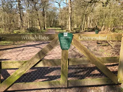 a gate with a sign that reads warden asbestos at Tiny House Boatshed in Heemstede