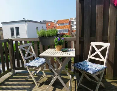 a table and two chairs on a balcony at Beachtime close to the beach, city centre in Zandvoort