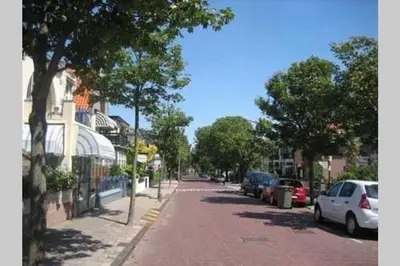 a street with cars parked on the side of the road at Beachtime close to the beach, city centre in Zandvoort