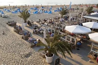 an overhead view of a beach with people on the sand at Beachtime close to the beach, city centre in Zandvoort