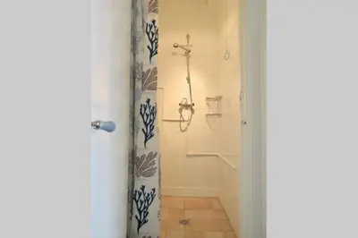a bathroom with a shower and a shower curtain at Beachtime close to the beach, city centre in Zandvoort