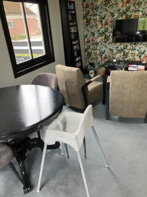 a living room with a table and chairs at Woudmeer 1 in Dirkshorn
