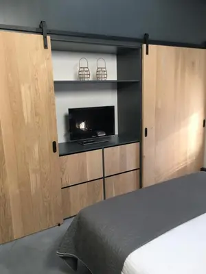 a bedroom with a bed and a fireplace in a room at Woudmeer 1 in Dirkshorn