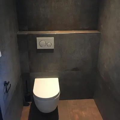 a bathroom with a toilet with the olympics on the wall at Woudmeer 1 in Dirkshorn