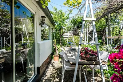 a ladder sitting next to a table with flowers at Hippie Beach in Zandvoort