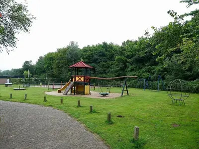 a park with a playground with a slide at Family Escape Near Keukenhof in Noordwijkerhout