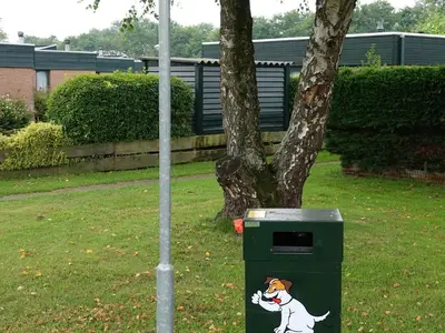 a trash can with a picture of a dog on it at Family Escape Near Keukenhof in Noordwijkerhout