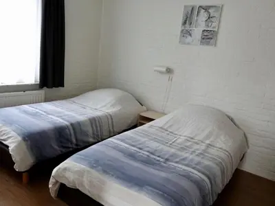 a bedroom with two beds and a window at Family Escape Near Keukenhof in Noordwijkerhout
