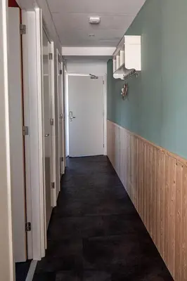 a hallway with blue walls and a white door at 4T4 Apartment B in Egmond aan den Hoef
