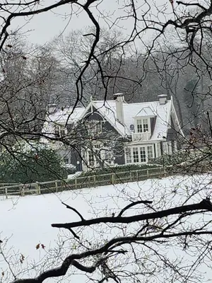 a large white house with a snow covered yard at Huize Koempoelan in Naarden