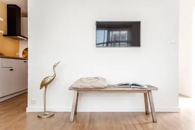 a table in a living room with a bird on it at The Shell Apartment in Zandvoort