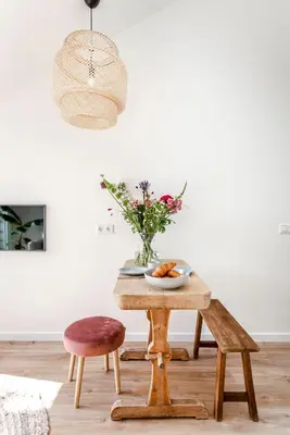 a table with a bowl of fruit and a vase of flowers at SeatheDunes in Zandvoort