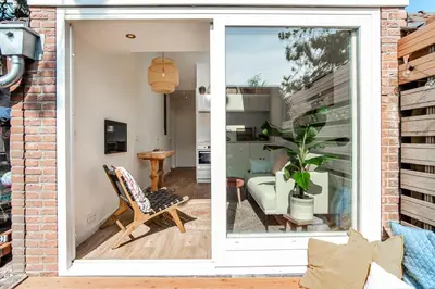 a brick house with a sliding glass door at SeatheDunes in Zandvoort