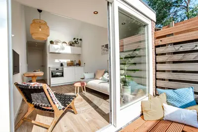 a small living room with a sliding glass door at SeatheDunes in Zandvoort