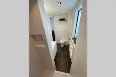 a bathroom with a toilet and a sink at Stella Maris Dune Apartment in Zandvoort