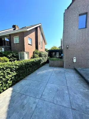a concrete sidewalk in front of a brick building at Stella Maris Dune Apartment in Zandvoort