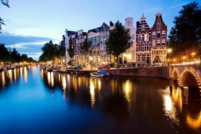 a view of a river with buildings and a bridge at Stella Maris Dune Apartment in Zandvoort