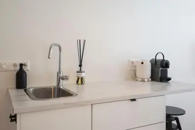 a kitchen with a sink and a counter top at Beach Studio Zen in the Centre of Zandvoort in Zandvoort