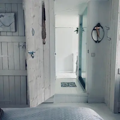 a door leading to a room with a mirror at Houseboat Bonnie in Amsterdam