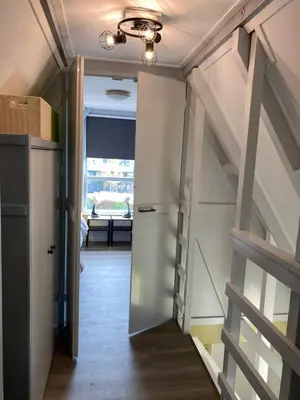 a hallway with a door leading into a room at Happy Little Maya Bee in Nieuwe-Niedorp