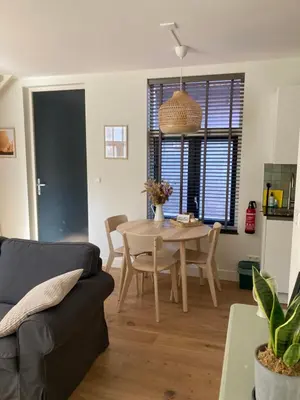 a living room with a table and a couch at Guesthouse Bonniehofje in Zandvoort