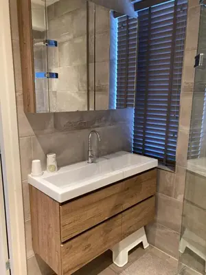 a bathroom with a sink and a mirror at Guesthouse Bonniehofje in Zandvoort