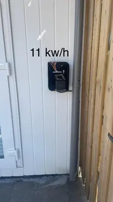a white garage door with a box on it at Royal Green in Zandvoort