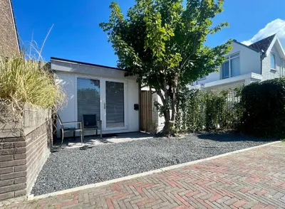 a house with a garage with a fence at Royal Green in Zandvoort