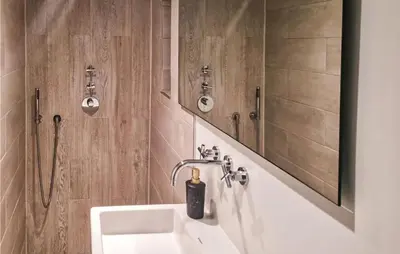 a bathroom with a sink and a mirror at Windwijser in Bergen aan Zee