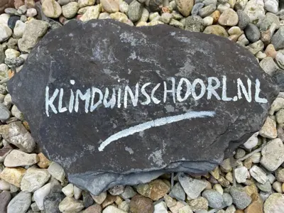 a rock with the word kununiversity written on it at The Forester Schoorl in Schoorl