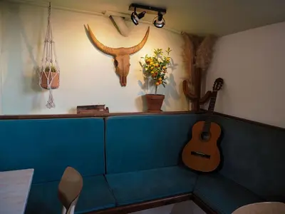 a guitar sitting on a bench in a room at FLOW in Amsterdam