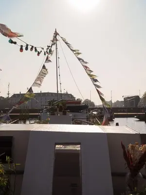 a boat with flags on top of a building at FLOW in Amsterdam