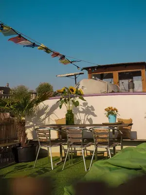 a patio with a table and chairs and plants at FLOW in Amsterdam