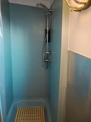 a bathroom with a shower with a bench in it at FLOW in Amsterdam