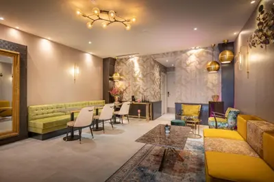 a living room with a couch and a table and chairs at Hotel Oscar in Amsterdam