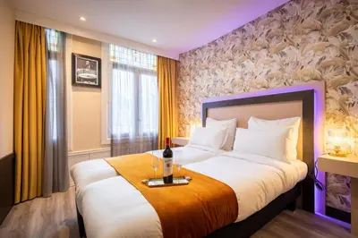 a bedroom with a large bed with a table on it at Hotel Oscar in Amsterdam